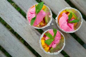 Fruit salad with strawberry ice cream photo
