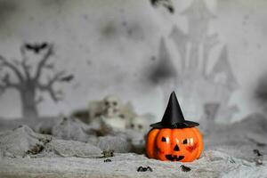 Orange scary pumpkin with witch hat. Halloween background. photo
