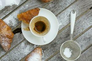 A dirty cup after coffee on a wooden surface. photo