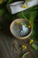 Linden facial powder mask in a clay pot. photo