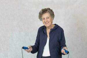 Senior woman is dressed in a sport costume photo