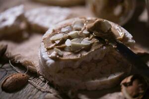 Homemade almond butter on a slice of rice crispbread. photo