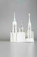 Ultrasonic toothbrush kit on a gray background. photo