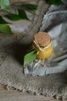 Honey with birch bark extract in a glass bottle. photo