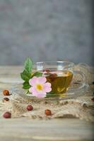 Rose hip herbal tea on a wooden surface. Free text. photo