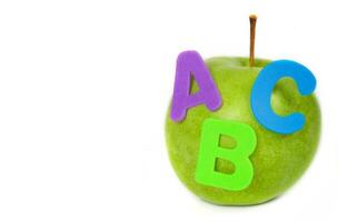 Apple and A,B,C letters attached to it. Closeup photo