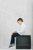 Boy and an old TV. Free space for a text. photo