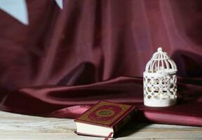 Sacred book of Quran on a wooden surface. photo