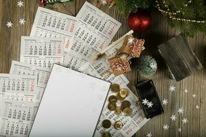 Blank sheet of paper and small purse with coins on the New Year's background. photo