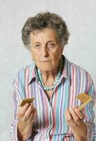 Senior woman and a broken wooden made hair comb photo