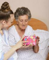 Geriatrician visits a senior woman photo