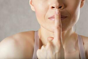 Young lady asks for silence. Closeup photo