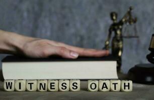 Word WITNESS OATH composed of wooden letters. photo