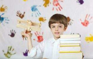 Boy of seven years old with books. Back to school photo