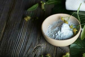 Linden facial powder mask in a clay pot. photo