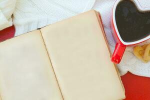 An open book and a cup of tea photo