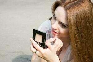 Young attractive woman is preparing for a photo session