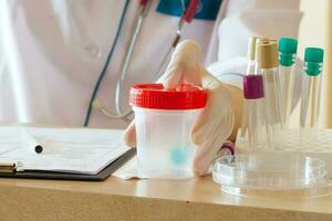 Collection cup for routine urine test. Closeup photo