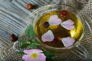 Rose hip herbal tea on a wooden surface. Free text. photo