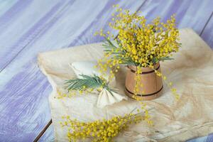 Mimosa flowers on a wooden surface. Closeup photo