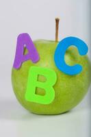 Apple and A,B,C letters attached to it. Closeup photo