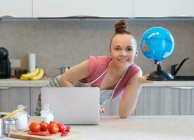 Young housewife in the kitchen photo