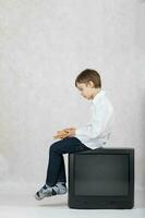 Boy and an old TV. Free space for a text. photo