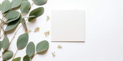 Minimalist Greeting Card Mockup with Delicate Dry Eucalyptus Leaves - Top View on a Clean White Background, AI Generated photo