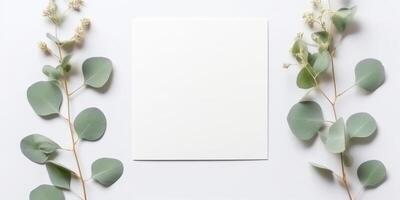 Minimalist Greeting Card Mockup with Delicate Dry Eucalyptus Leaves - Top View on a Clean White Background, photo
