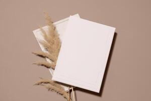 Mockup Paper Wedding Invitation Boho Minimal Style Greeting Card for Wedding Invitations and Birthday Stationery. Top View Flat Lay Copyspace. photo