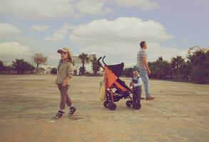 Father and two sons on open space. Vintage style photo