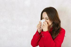 A sneezing young woman dressed in a classical costume. photo