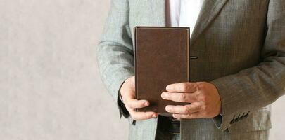 A book in a man's hands. Closeup photo