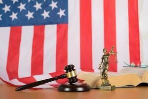 Statue of Themis and judge's gavel on a table. photo