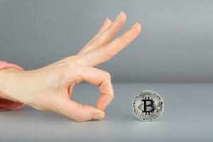 Bitcoin and human hand. photo