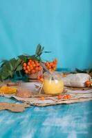 Rowan berries, glass with honey and honeycomb on a sackcloth. . photo