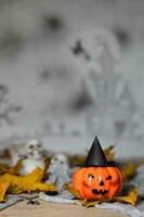 Orange scary pumpkin with witch hat. Closeup photo