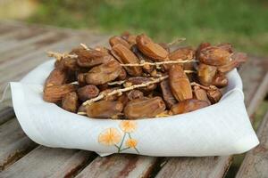 Tunisian dates on a twig in the woven plate photo