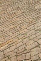 Paved road with brown cobblestone photo