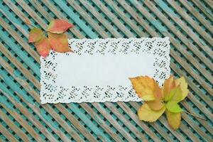 Decorative lace napkin on an old wooden surface photo