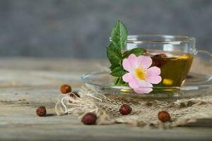 Rose hip herbal tea on a wooden surface. Free text. photo