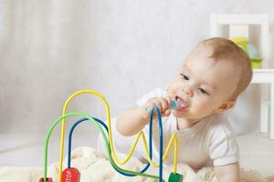 A baby girl of eight months is playing in her room photo