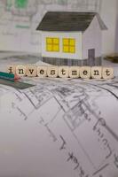 Word INVESTMENT composed of wooden letters. Closeup photo