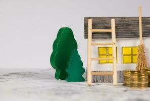 Paper house, wooden small trees, ladder and sweeper on a technical drawing. photo