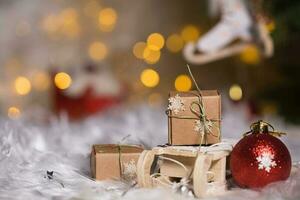 Winter holidays background Christmas presents on mini wooden sleigh. photo