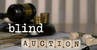 Word BLIND AUCTION composed of wooden dices. photo