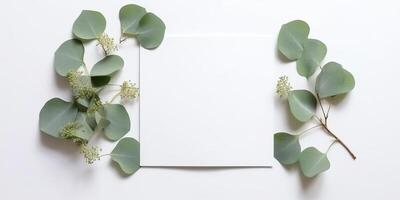 Minimalist Greeting Card Mockup with Delicate Dry Eucalyptus Leaves - Top View on a Clean White Background, photo