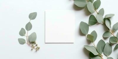 Minimalist Greeting Card Mockup with Delicate Dry Eucalyptus Leaves - Top View on a Clean White Background, AI Generated photo