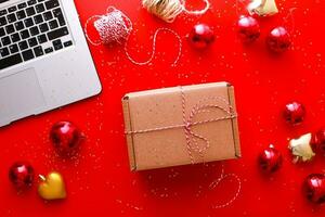 Flat lay gift wrapping on red background. Craft gift. Online shopping for Christmas photo