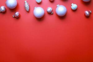 Flat lay Christmas toys on a red background. Pink toys for the Christmas tree photo